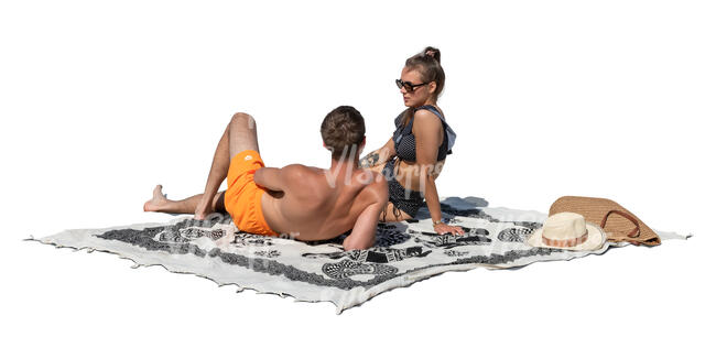 couple sunbathing and talking on the beach