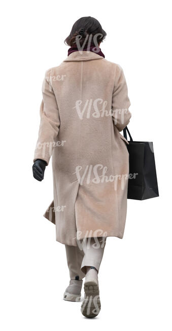 woman in a light beige overcoat walking