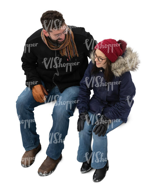 man and woman in winter sitting seen from above