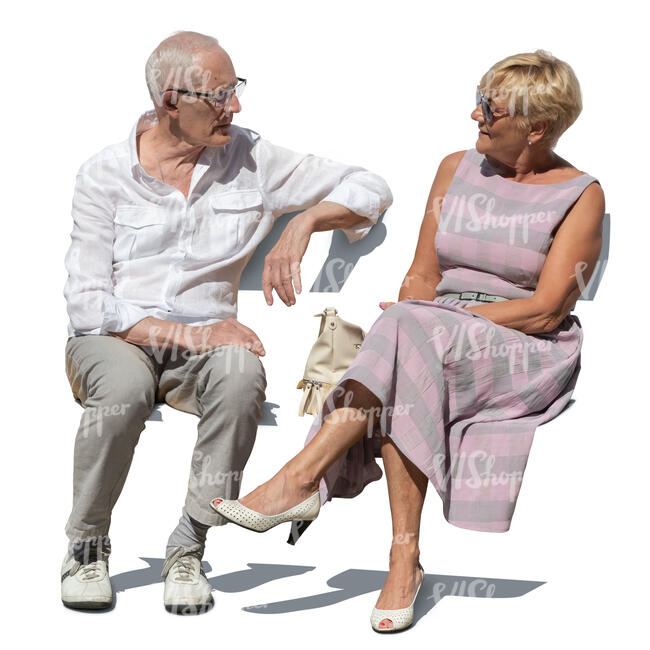 two senior citizens sitting and talking outside in summer