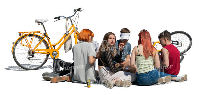 group of teenagers sitting on the ground