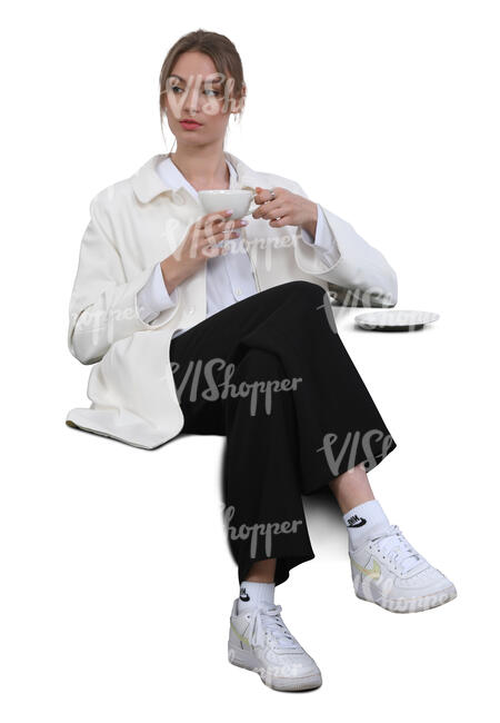 woman sitting in a lounge and drinking coffee