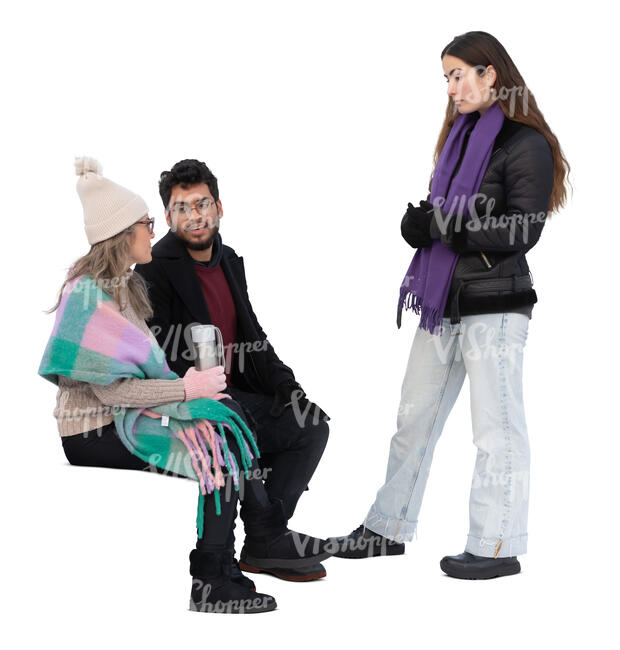 two people sitting and talking to a woman standing in front of them