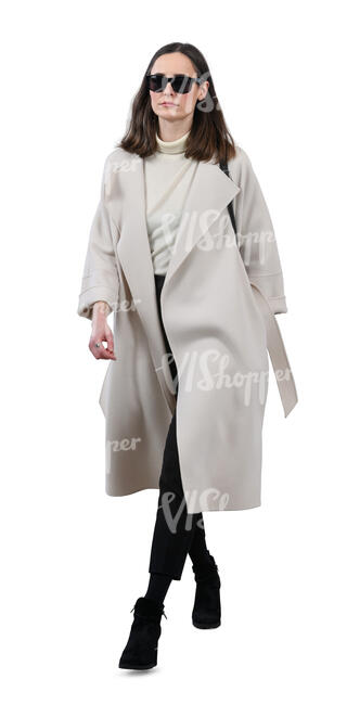 woman in a white overcoat walking