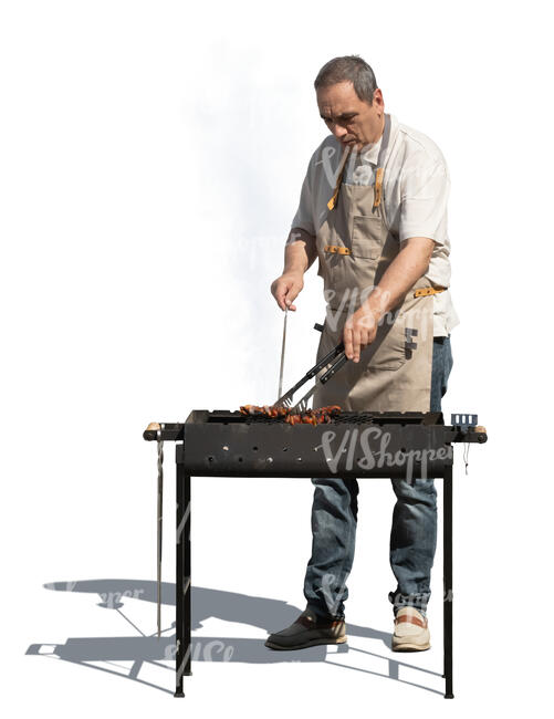 man cooking over an outdoor grill