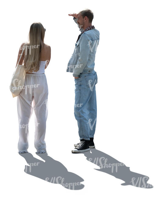 two backlit people standing and looking into distance