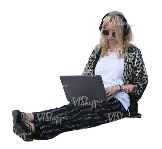 woman with a laptop sitting on the ground