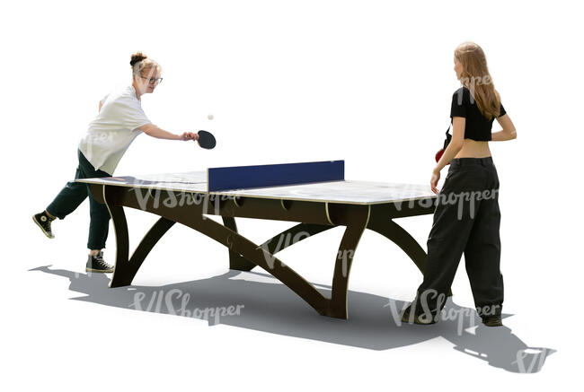 two backlit women playing ping pong outside