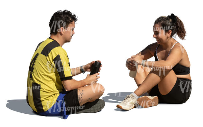 man and woman sitting on the ground and resting after workout