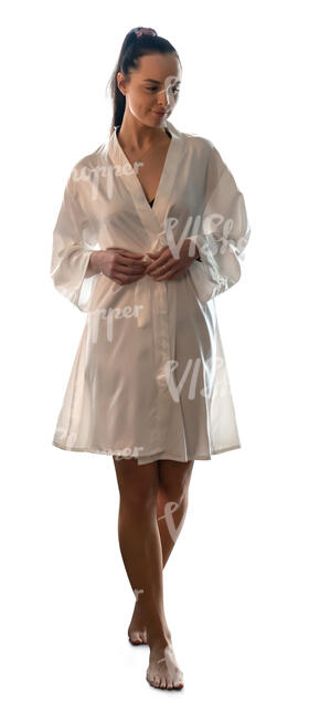 woman in a silky bathrobe walking barefoot