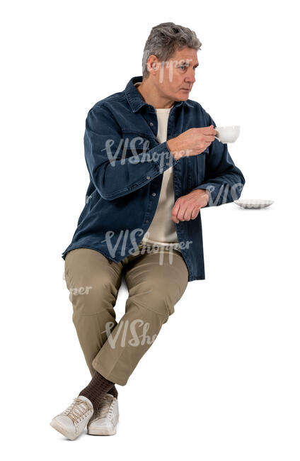older gentleman sitting and drinking coffee
