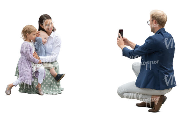 man taking a picture of his wife and kids