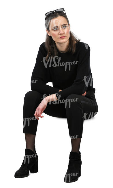 woman in a black outfit sitting