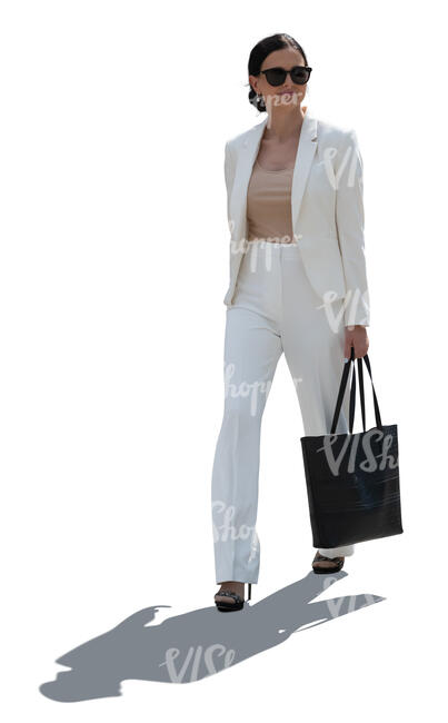 backlit woman wearing a white suit walking