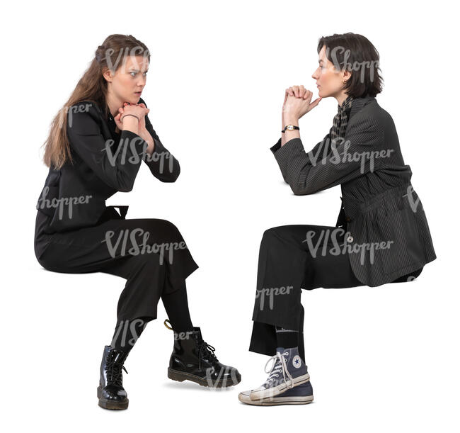 two women sitting and talking