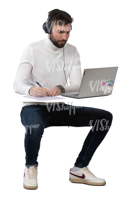 man working at a desk with computer