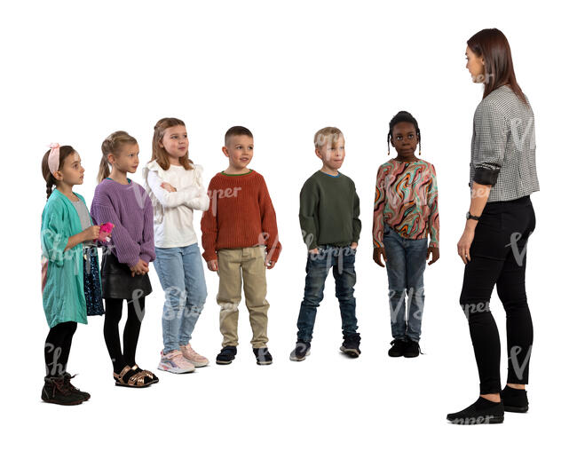 group of children standing and listening to a teacher