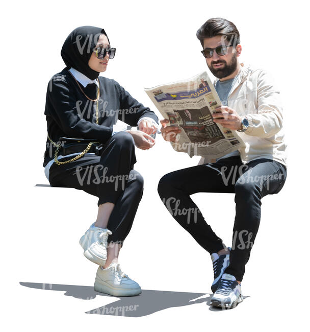 man and woman sitting and reading newspaper