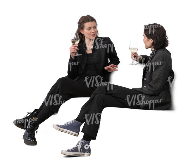 two women sitting and drinking wine and talking