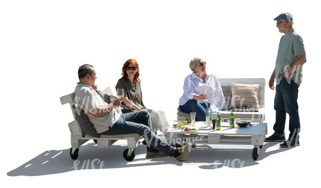 backlit group of older people relaxing in the garden