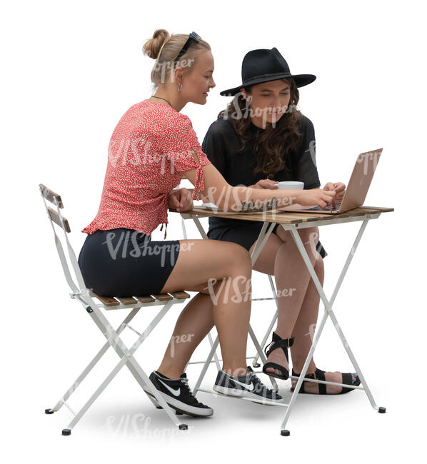 two young women sitting nad looking at a laptop