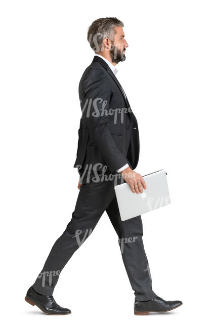 man in a suit and carrying a laptop walking