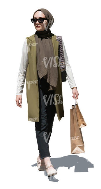 elegant muslim woman with shopping bags walking