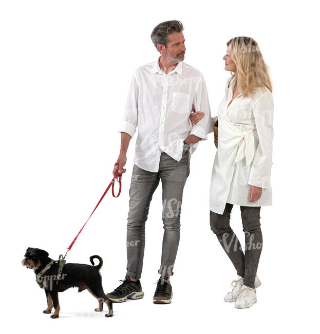 man and woman with a dog standing
