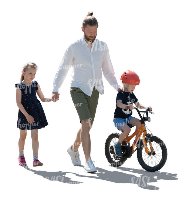 backlit man with two kids walking