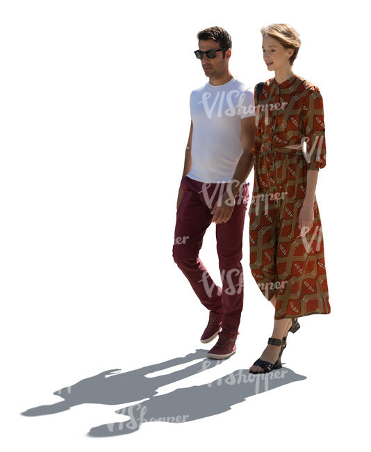 backlit man and woman walking