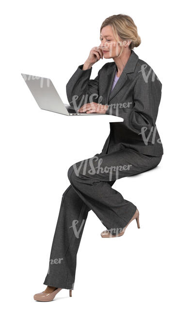 woman sitting at a counter table and working with laptop