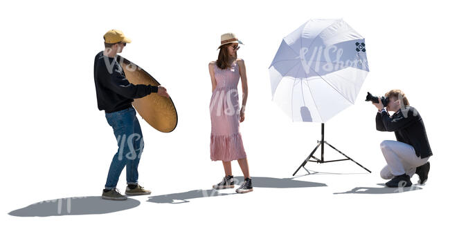 backlit scene of a photo shoot with a female model and photography team