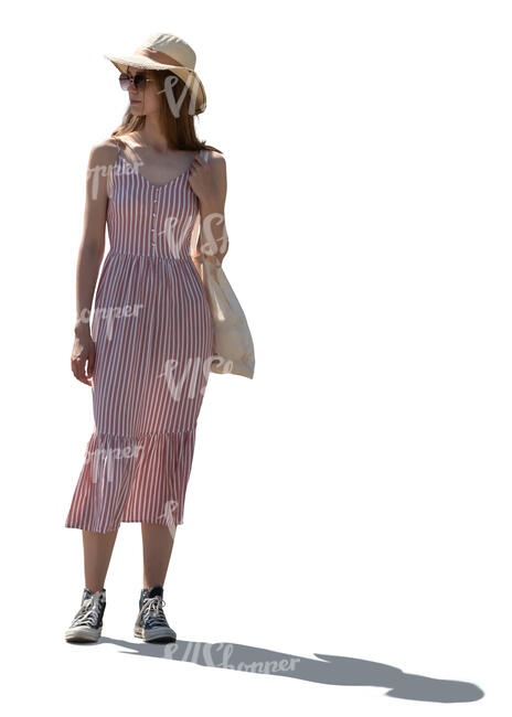 backlit woman in a summer dress standing