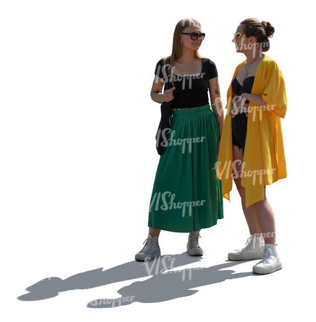 two backlit women standing and talking