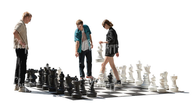 backlit group playing chess in the street