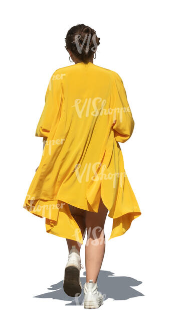 woman in a yellow flowy jacket walking
