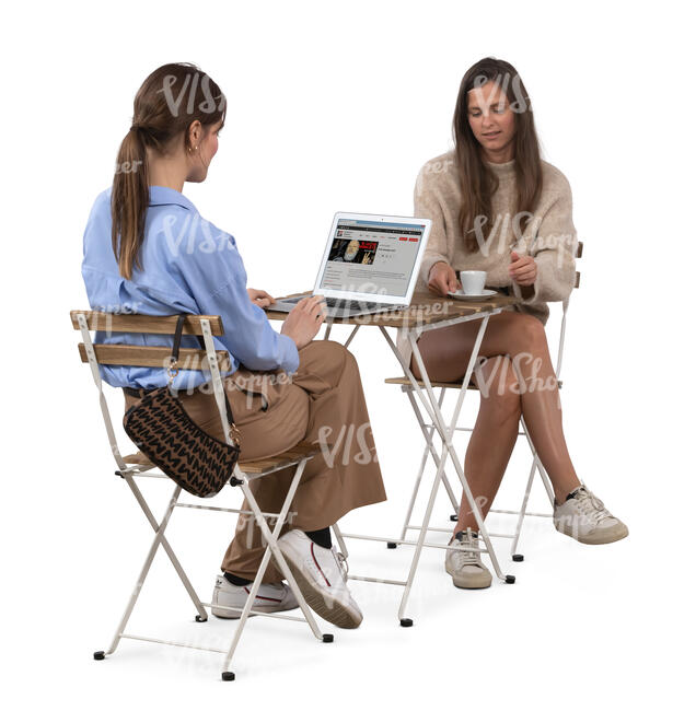 two women sitting in a coffeeshop with laptop
