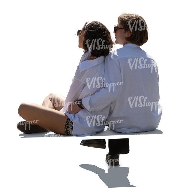 backlit young couple sitting