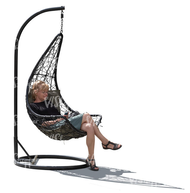 backlit woman sitting in a hanging chair