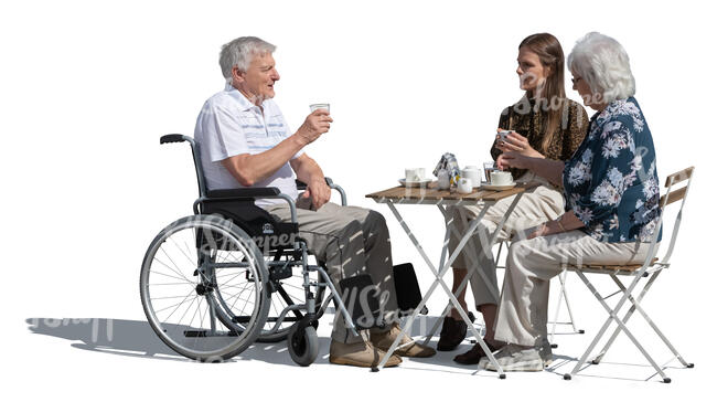 older man in a wheelvhair sitting in a cafe with family