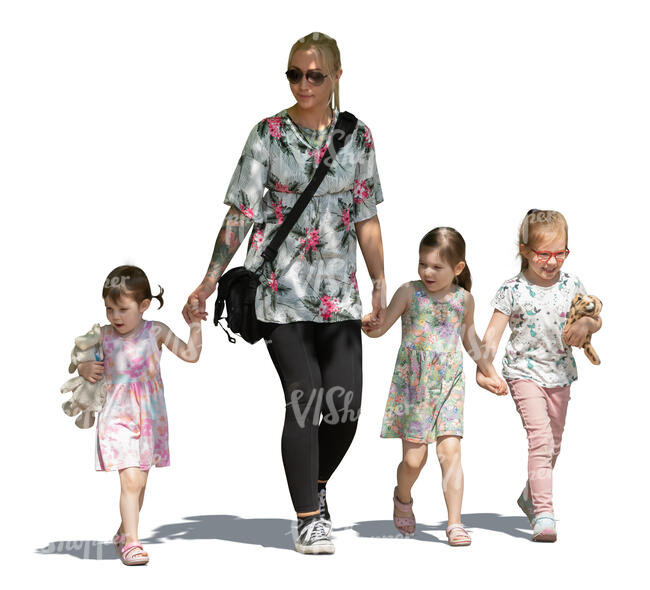 woman with three girls walking hand in hand in tree shade