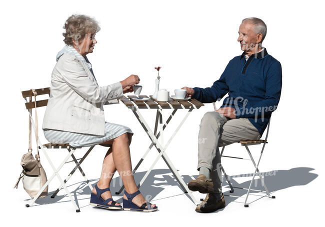 elderly couple sitting in an outdoor cafe