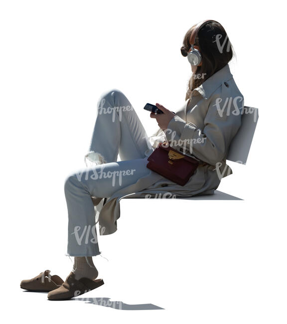 backlit woman sitting and listening to music