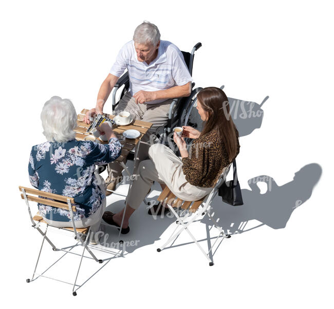 man in a wheelchair sitting in a cafe with his friends seen from above