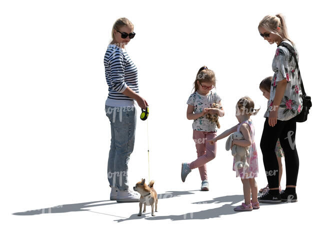backlit group of women and children and a dog