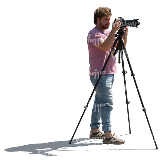 backlit man with a photo camera standing