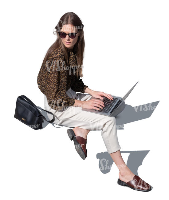 woman with laptop sitting outside seen from above