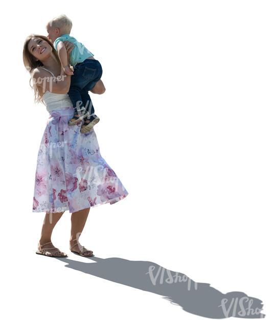 backlit woman lifting up her son