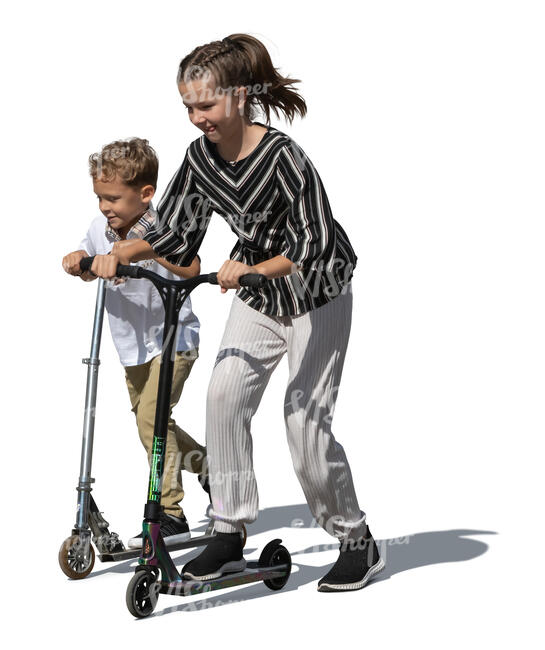 two kids with scooters riding happily