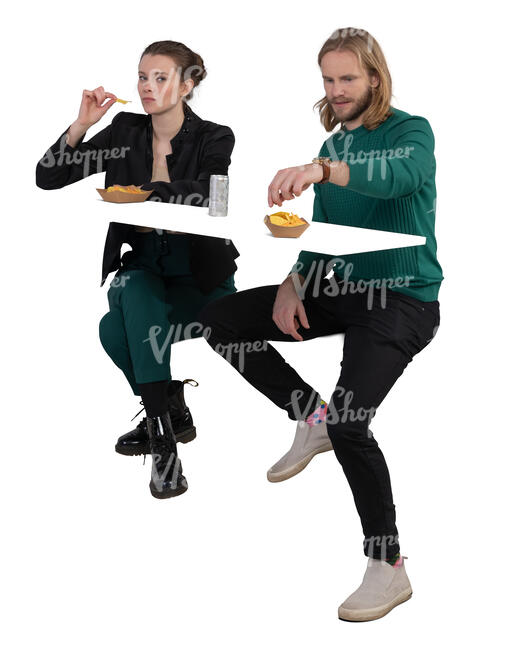 man and woman sitting and eating chips at a counter table